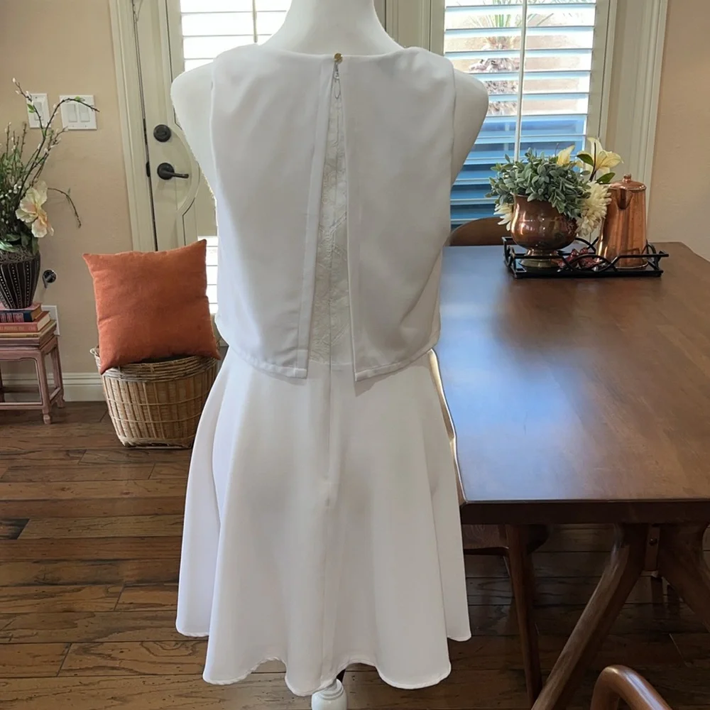 BEBE LWD Round Neck Sleeveless Ruffle hem Cute Short Dress. Lace Details. Size M